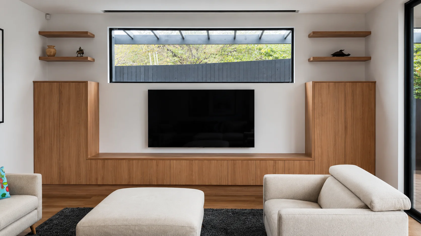 Custom modern living room wall units with a mix of matte cabinets, open bookshelves, and a centralized entertainment layout maximizing vertical wall space.